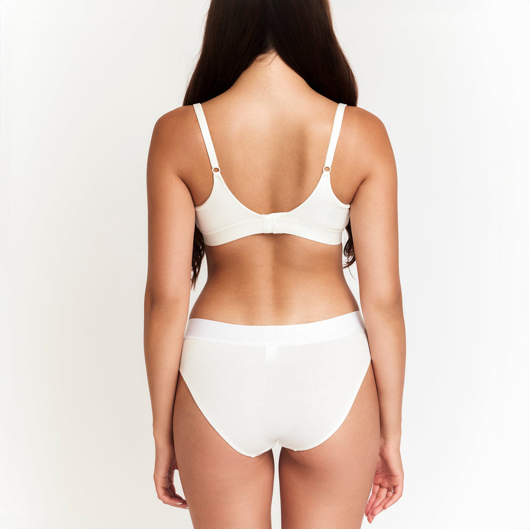 White mid-rise brief viewed from back, seamless look and wide stretch waistband