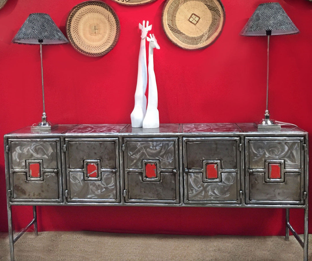 Distressed metal credenza with five drawers and red square insets, metal legs.