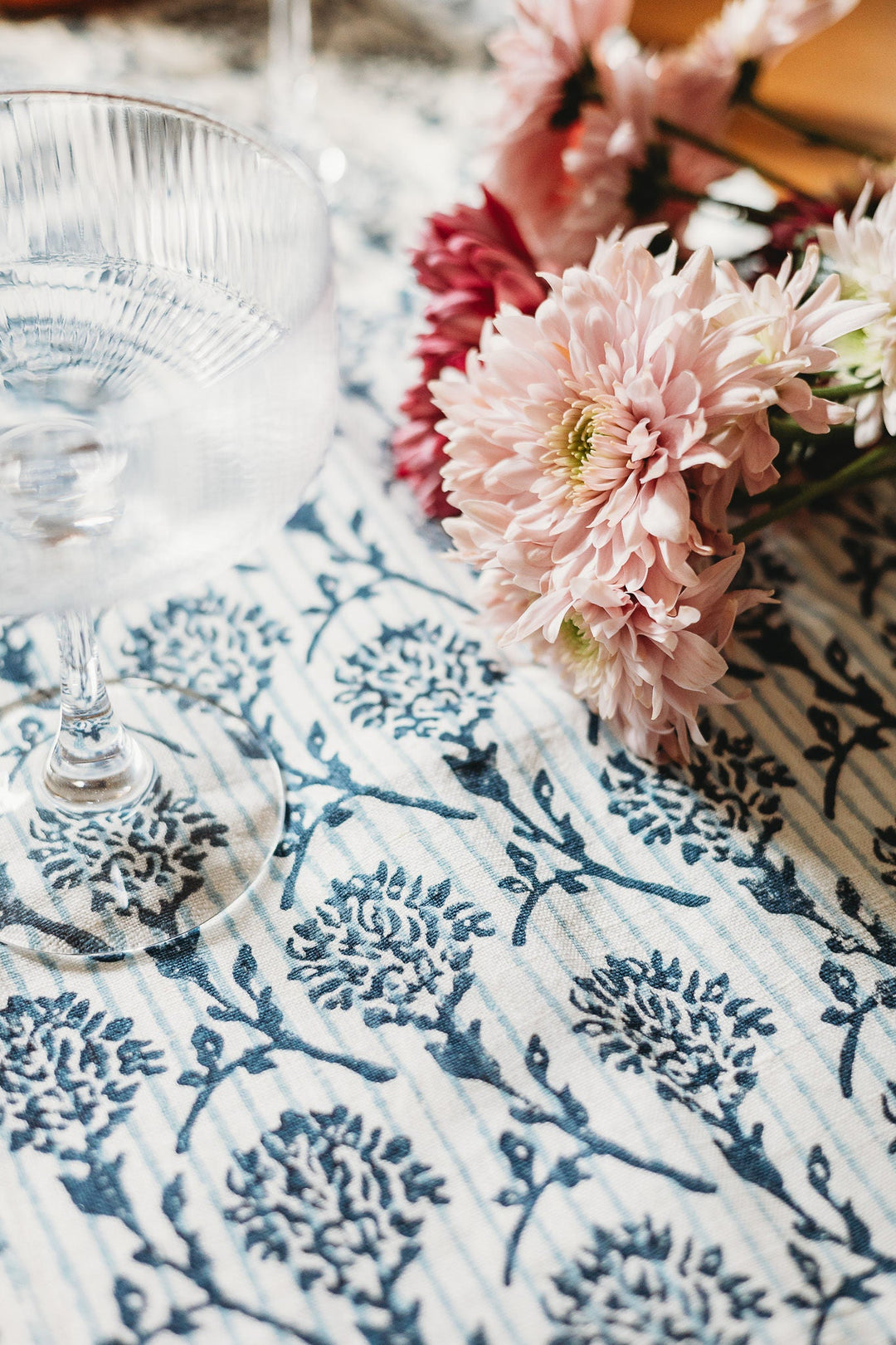 Linen runner close-up with blue botanical print and visible woven texture