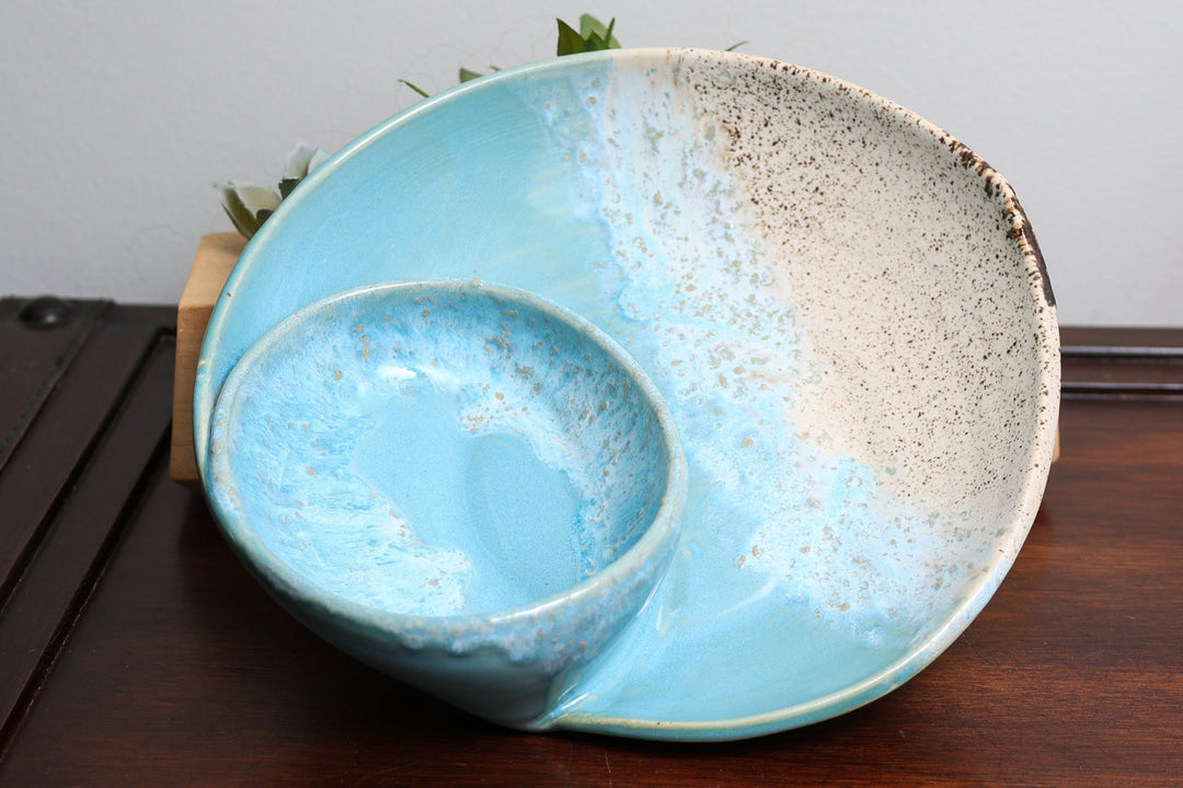 Coastal ceramic bowl with blue interior and beige speckled outer glaze, paired dish