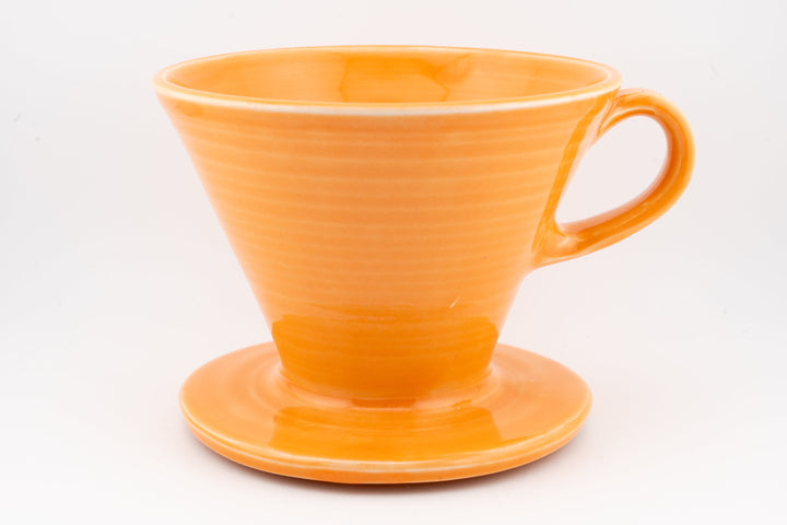 Orange ceramic pour-over dripper with side handle and circular base