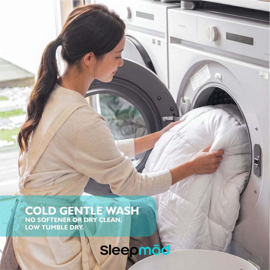 White cooling comforter inside a washing machine drum