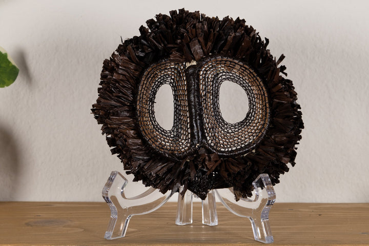 Fish-themed owlet mask with dark woven fringe and two oval mesh eye cutouts