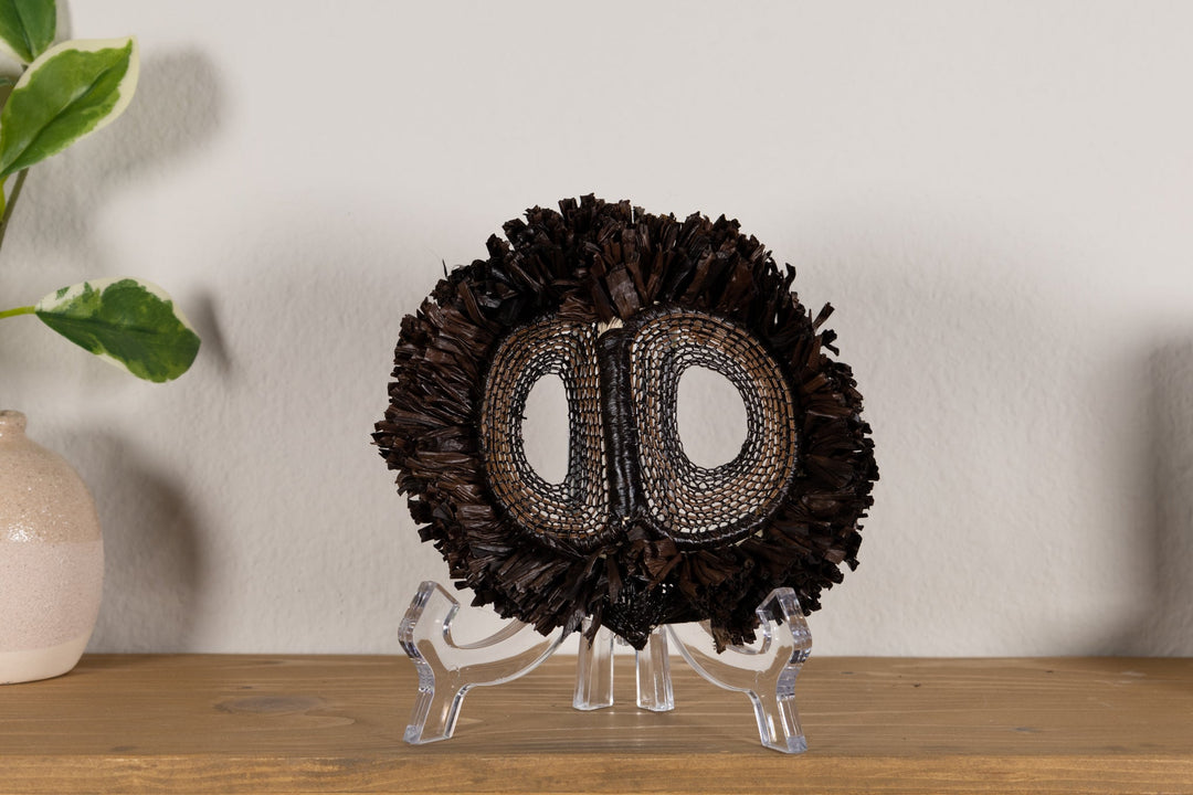 Fish-themed owlet mask with dark woven fringe and two oval mesh eye cutouts