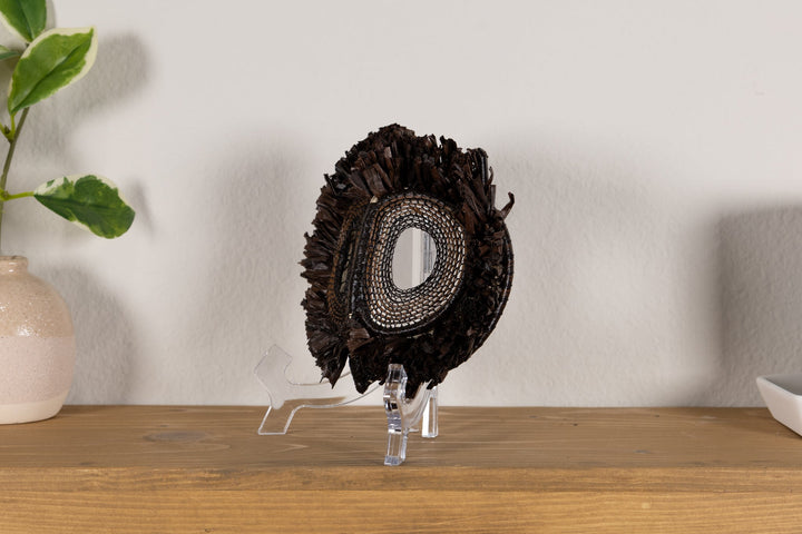 Fish-themed owlet mask in dark woven fringe with one oval mesh eye cutout
