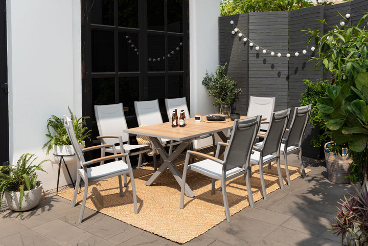Outdoor dining table set with light wood tabletop and gray mesh dining chairs