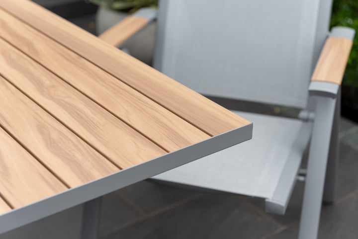 Close-up of light wood slatted tabletop on a gray metal extendable patio table