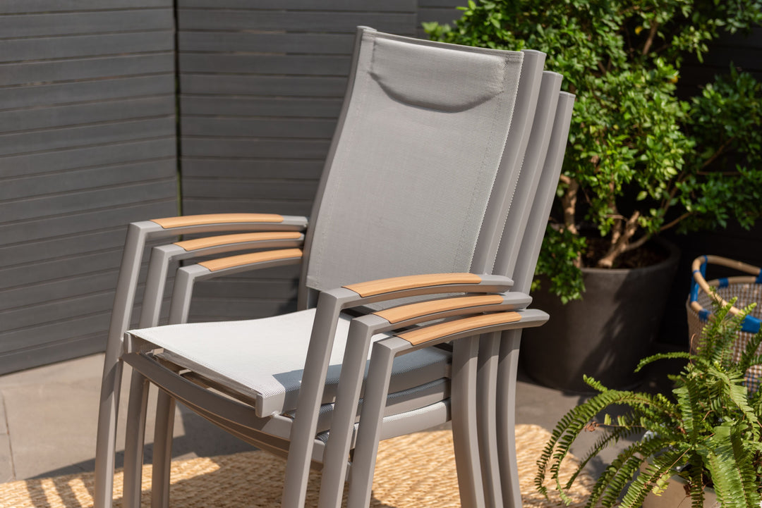 Outdoor dining chair with gray frame, white mesh seat, and light wood armrests