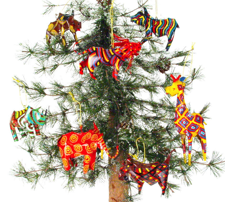 Colorful animal ornaments, including a hippo, hanging on a decorated tree