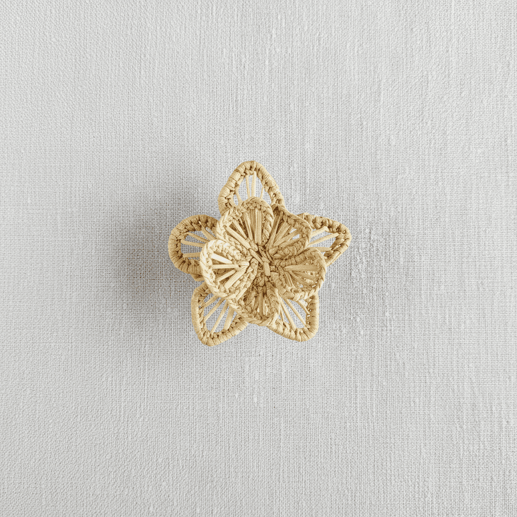 Handwoven star-flower napkin ring in lavender purple woven palm fibers