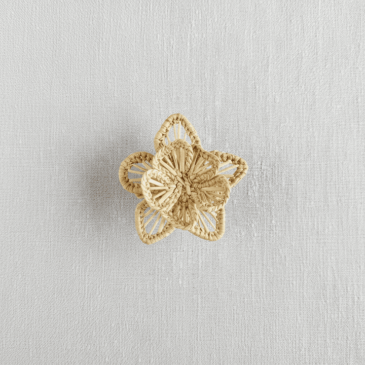 Handwoven star-flower napkin ring in lavender purple woven palm fibers