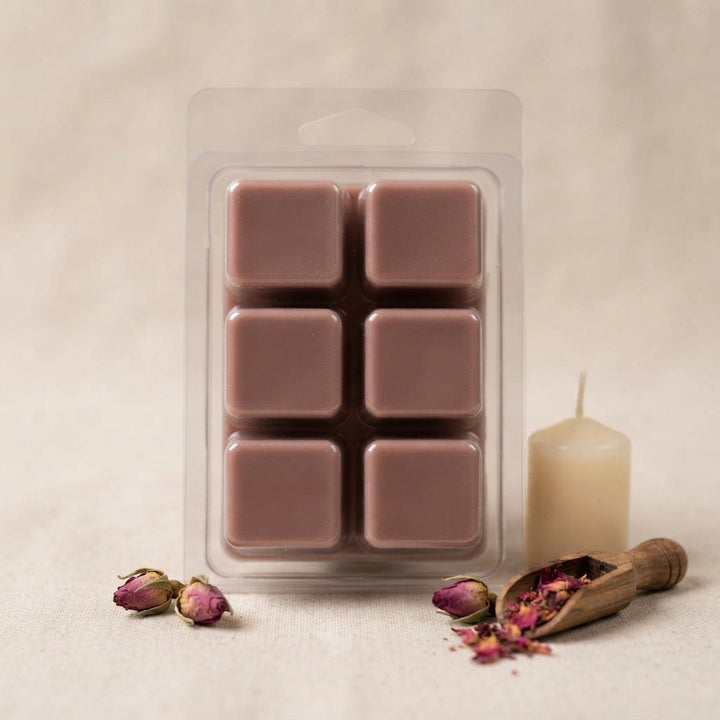 Dark brown and mauve wax melt cubes in clear 6-cube clamshell grid