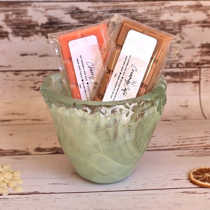Gift cup filled with individually wrapped wax melt bars in white, orange, and tan