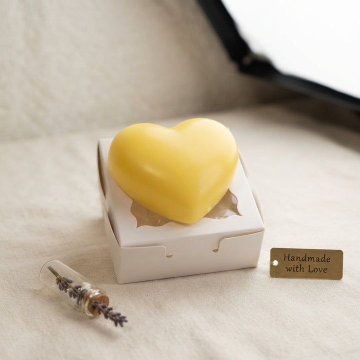 Yellow heart wax freshener in white gift box with scalloped heart opening