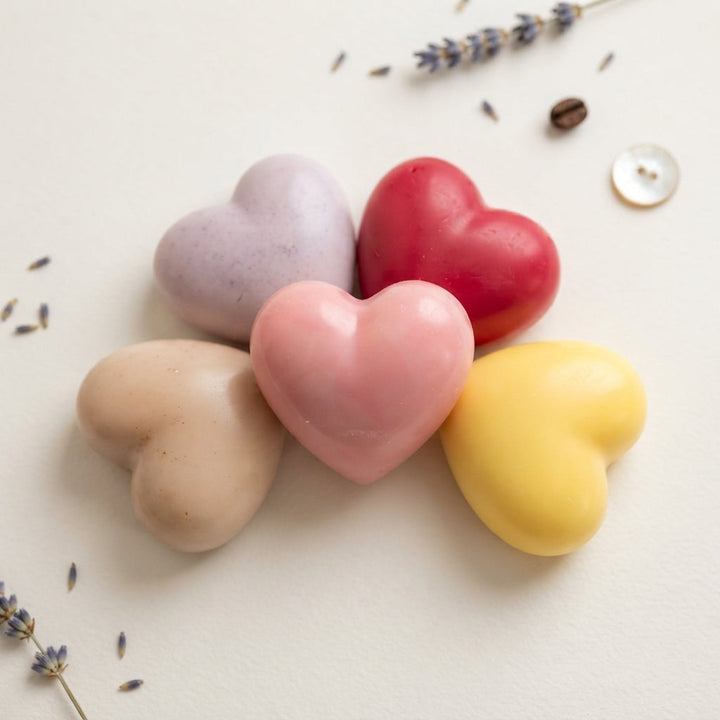 Four pastel heart wax fresheners stacked beside white gift box
