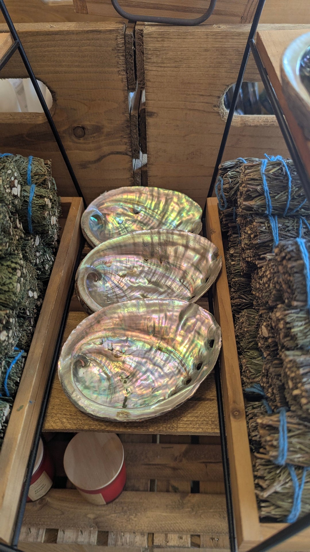 Abalone shell serving dish with iridescent mother-of-pearl in a wooden crate