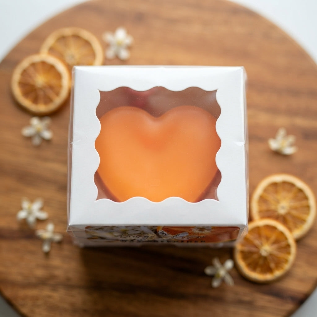 Orange heart wax freshener in white gift box with scalloped heart window