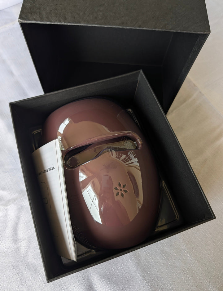 Brown face-and-neck mask and controller set inside black gift box