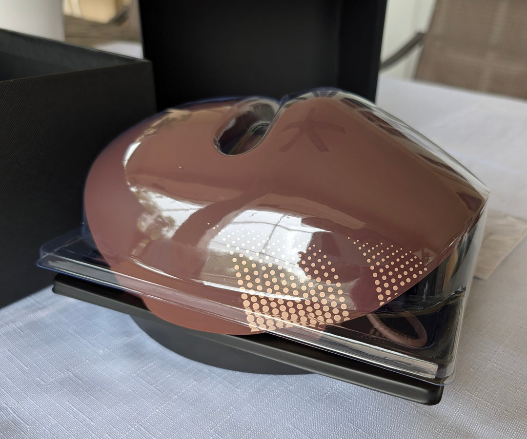 Brown LED therapy face mask in clear tray with controller and cable