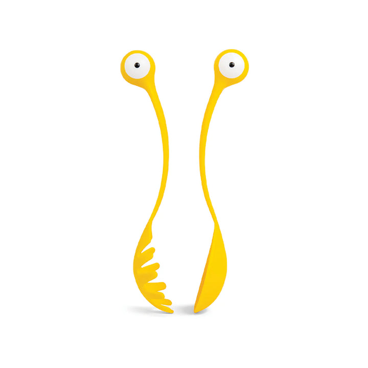 Yellow monster-shaped pasta server with two wiggly arms and white eye details