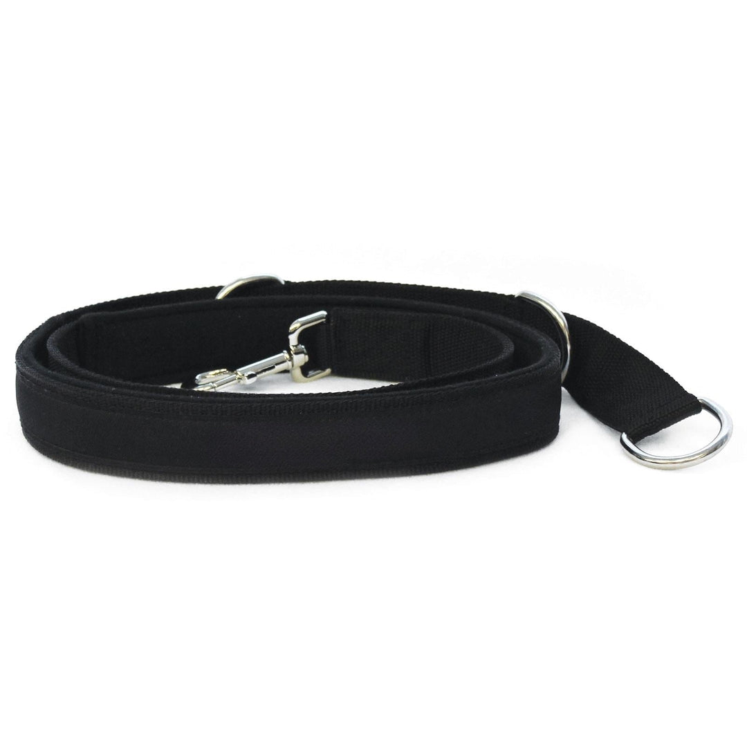 Black adjustable foot strap with metal buckle and D-ring for reformer use