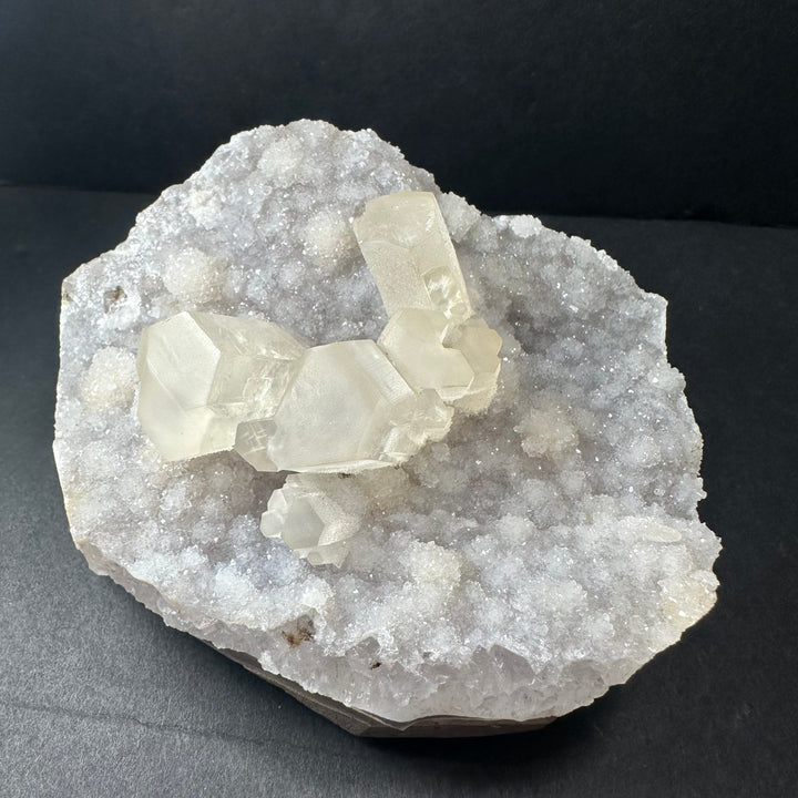 Druzy calcite cluster on light agate base, white crystals with glittery texture