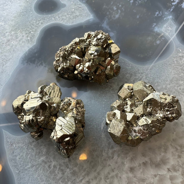 C Grade cubic pyrite crystal clusters in metallic gold, set of four