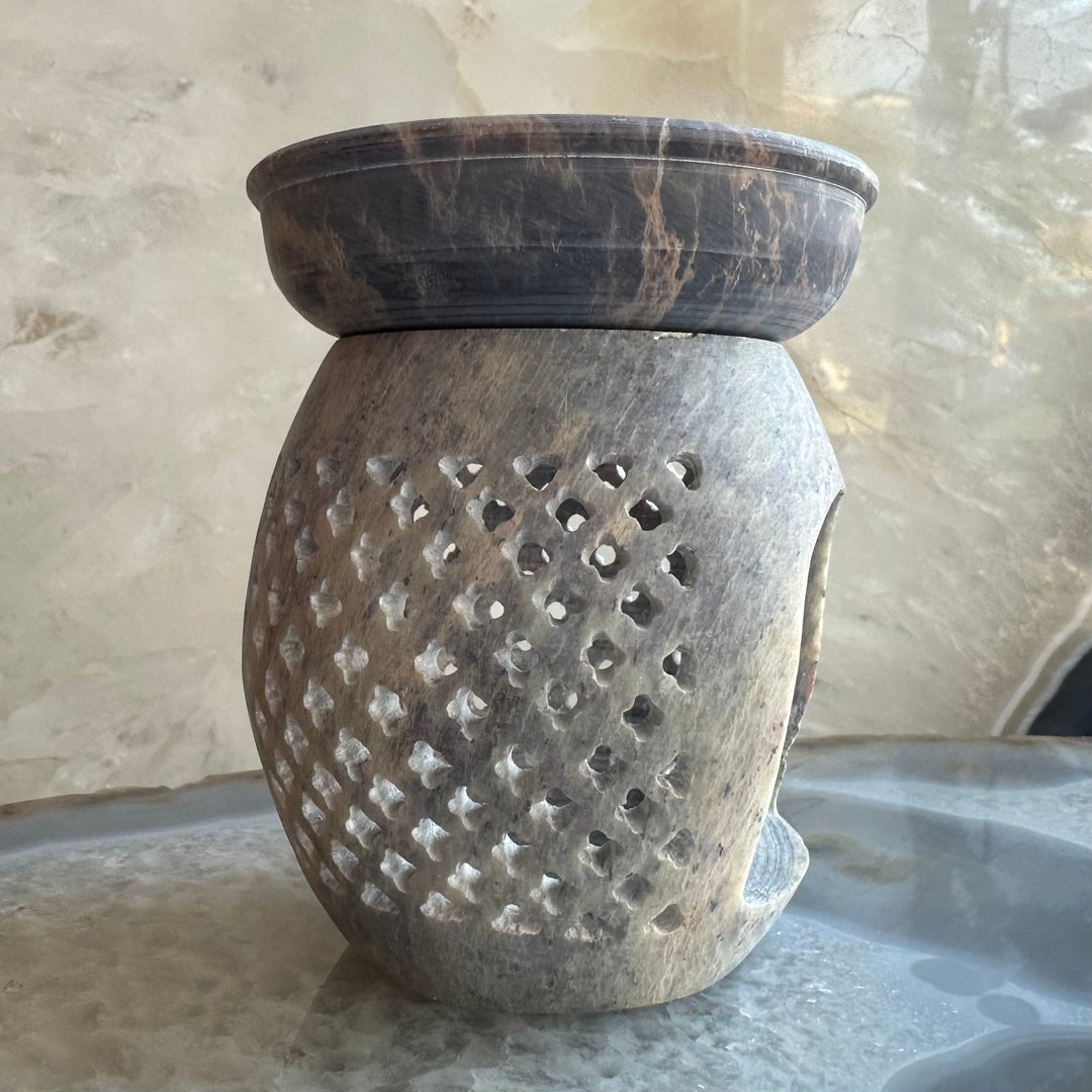 Carved soapstone essential oil burner with dense dotted cutout pattern, dark brown
