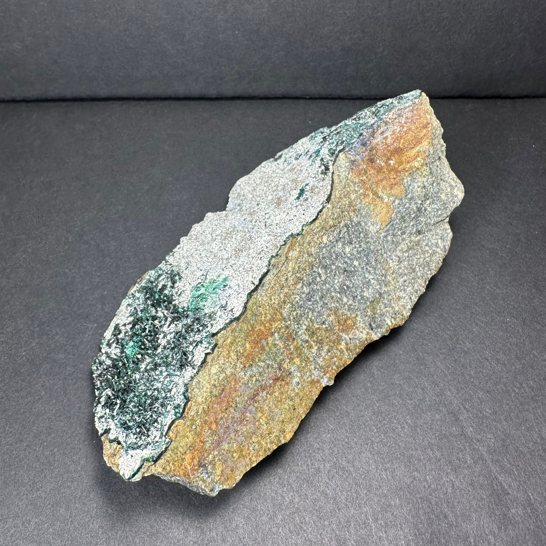 Epidote crystal cluster on matrix, green crystals with exposed rusty-brown rock edge