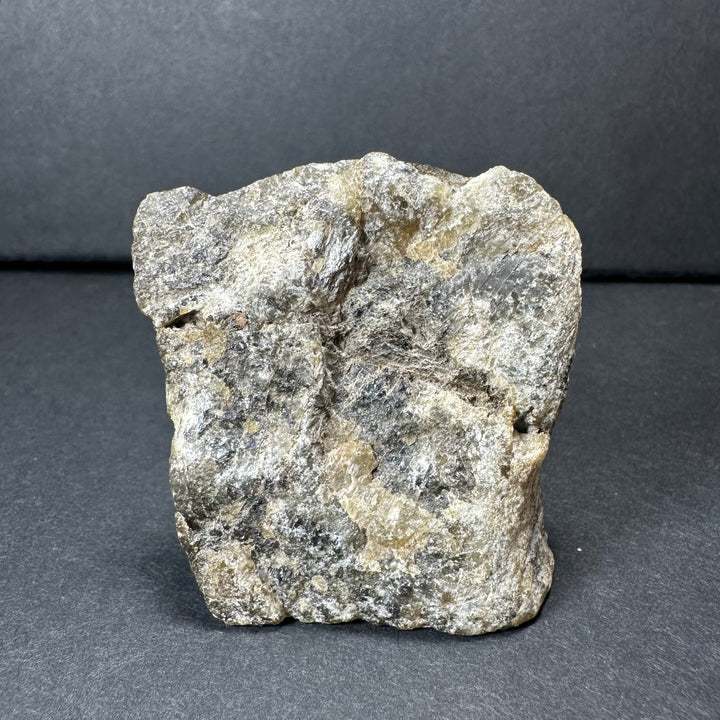 Labradorite rough stone with silver-gray surface and darker natural veining