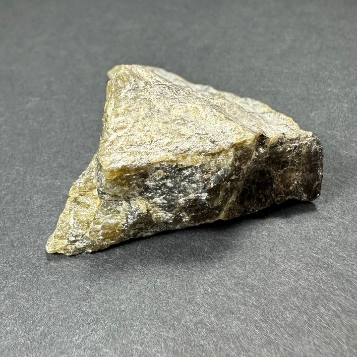 Labradorite rough stone, light cream body with dark matrix on one end