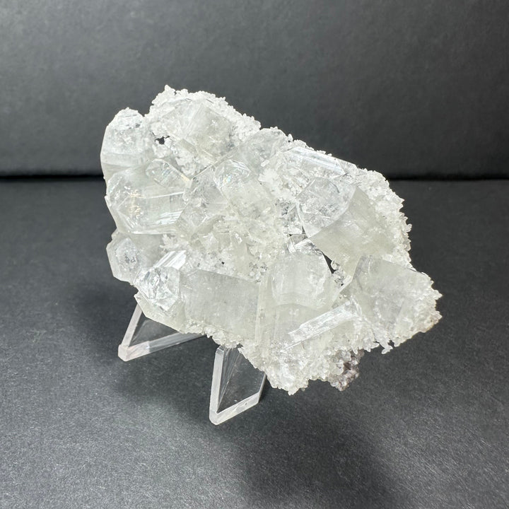 Clear apophyllite crystal cluster micro specimen with sparkling white crystal points on stand