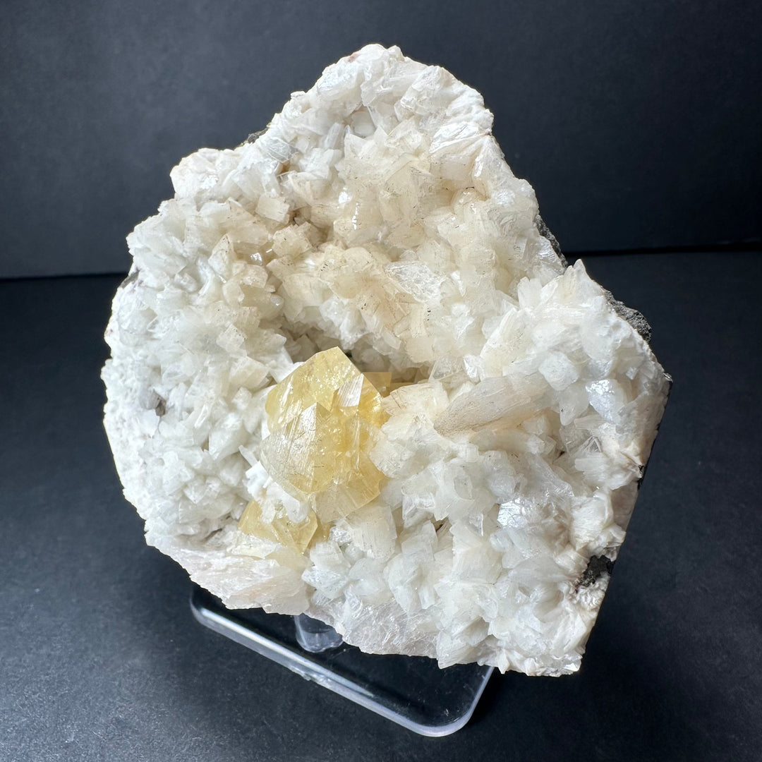 Yellow powellite and heulandite mineral specimen featuring white crystals and yellow inclusions