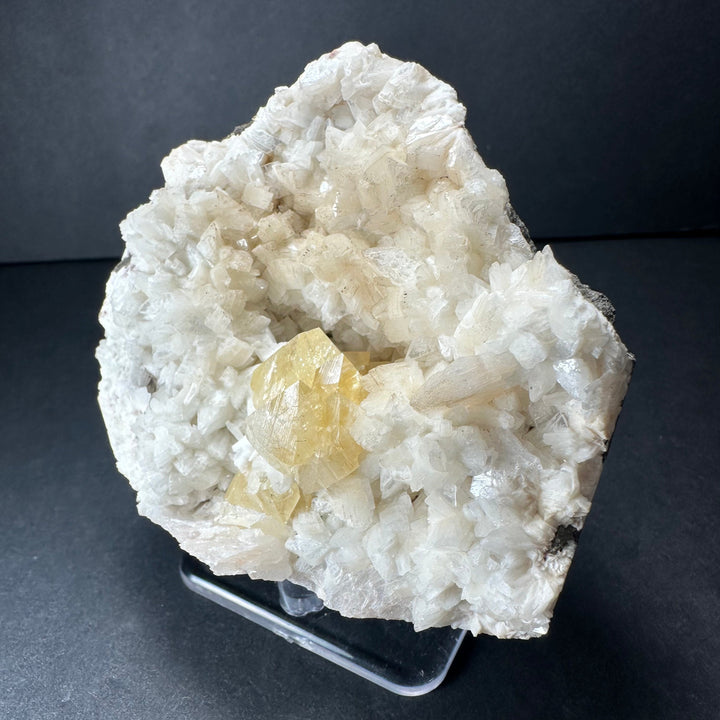 Yellow powellite and heulandite mineral specimen featuring white crystals and yellow inclusions
