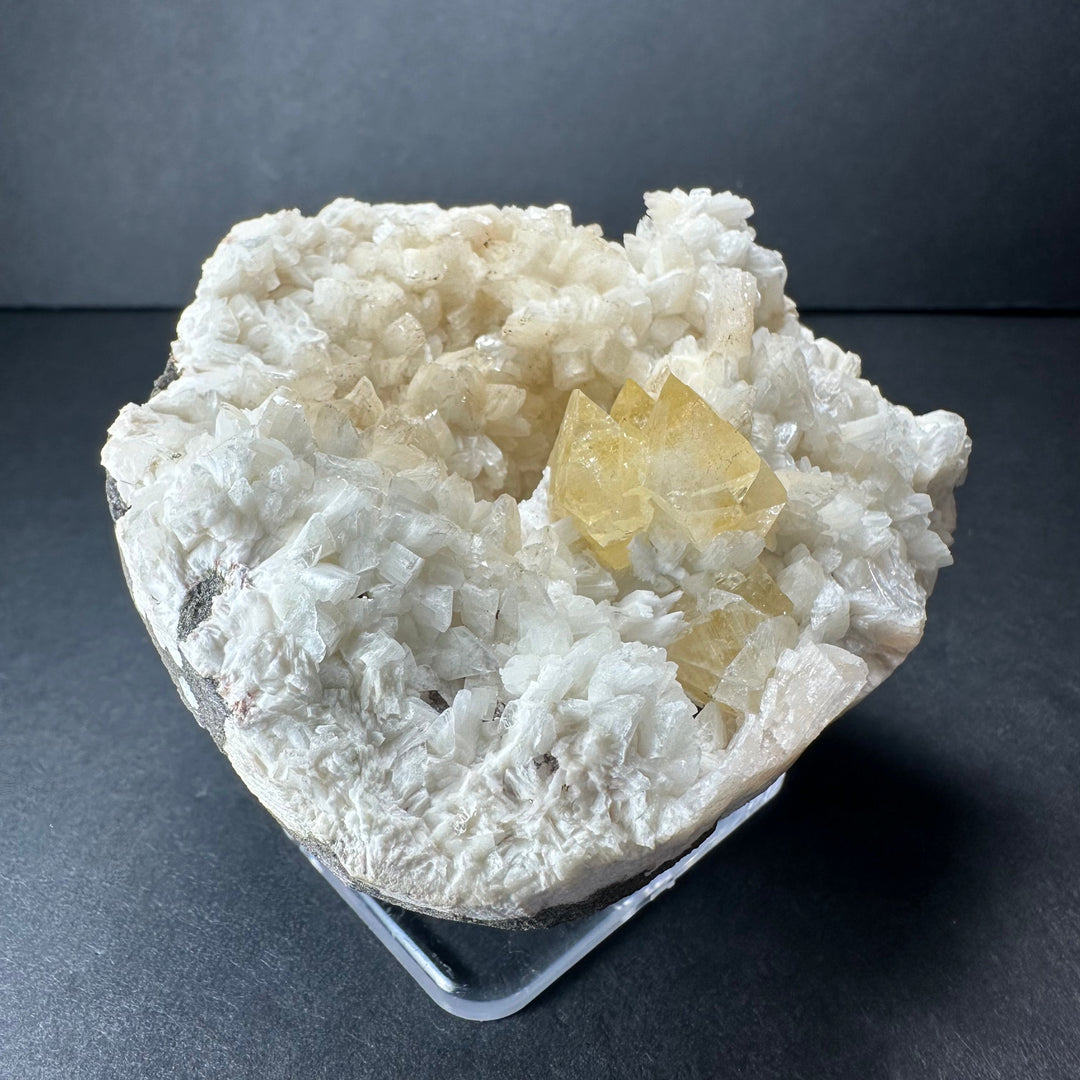 Yellow powellite and heulandite mineral specimen with white crystal cluster and yellow section
