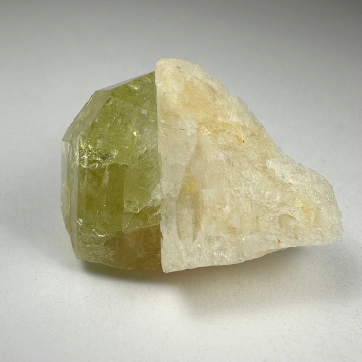 Green Brazilianite crystal with pale white Albite, jagged rough specimen