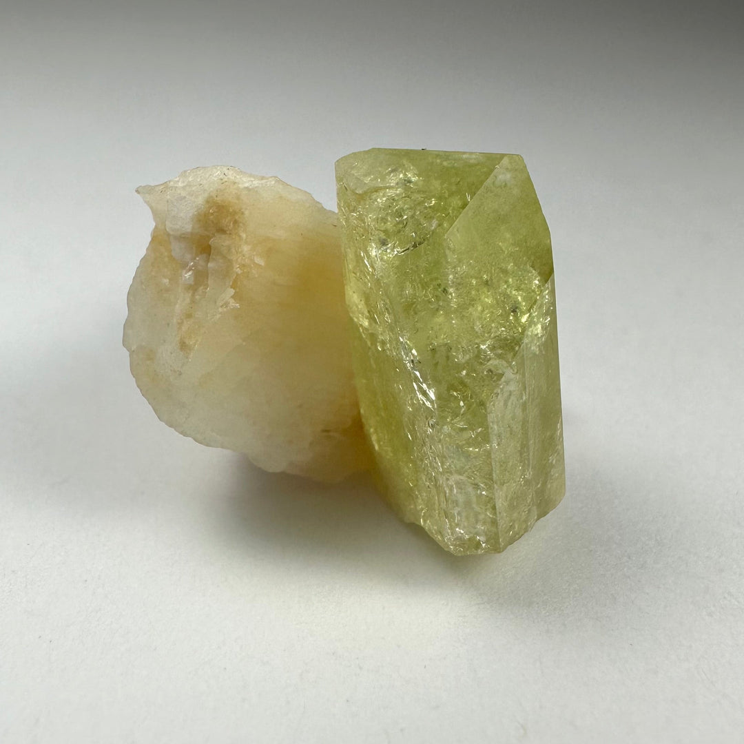 Green Brazilianite crystal with pale white Albite, clustered rough points