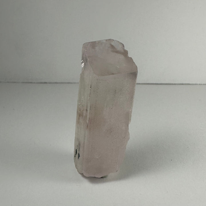 Terminated light pink kunzite crystal, rounded top, translucent prismatic body