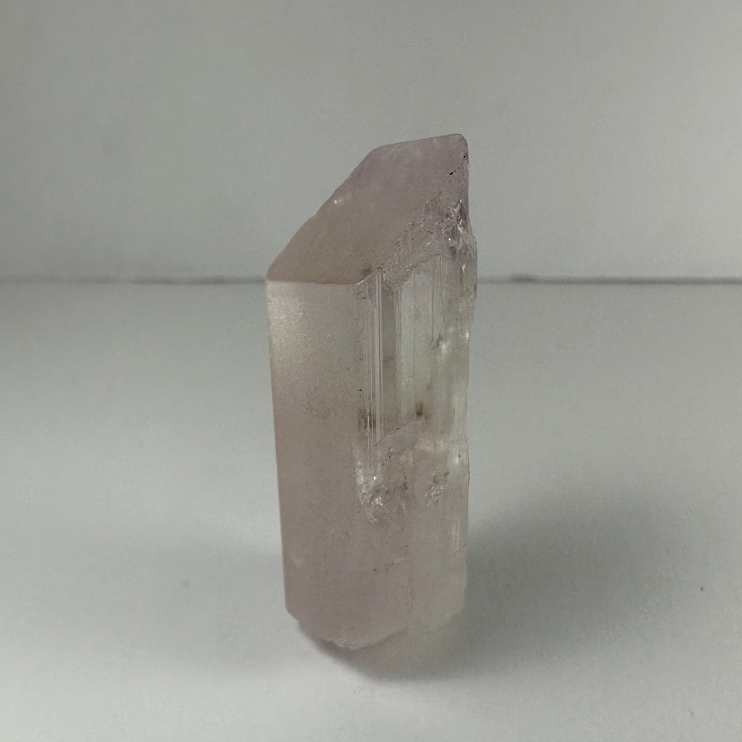 Terminated light pink kunzite crystal, translucent column with etched faces