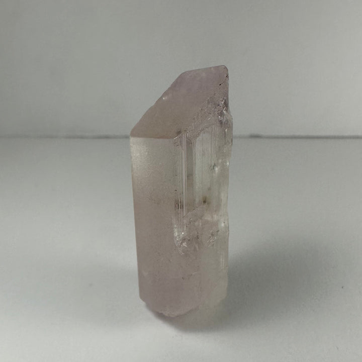 Terminated light pink kunzite crystal, translucent column with etched faces