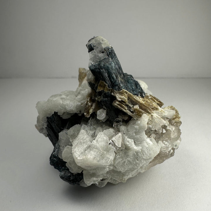 Mineral specimen with black tourmaline prism, translucent white quartz, gold mica