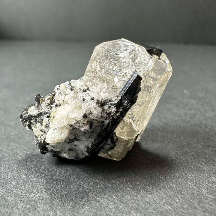 Mineral crystal specimen with clear white quartz, black tourmaline, and gray matrix.