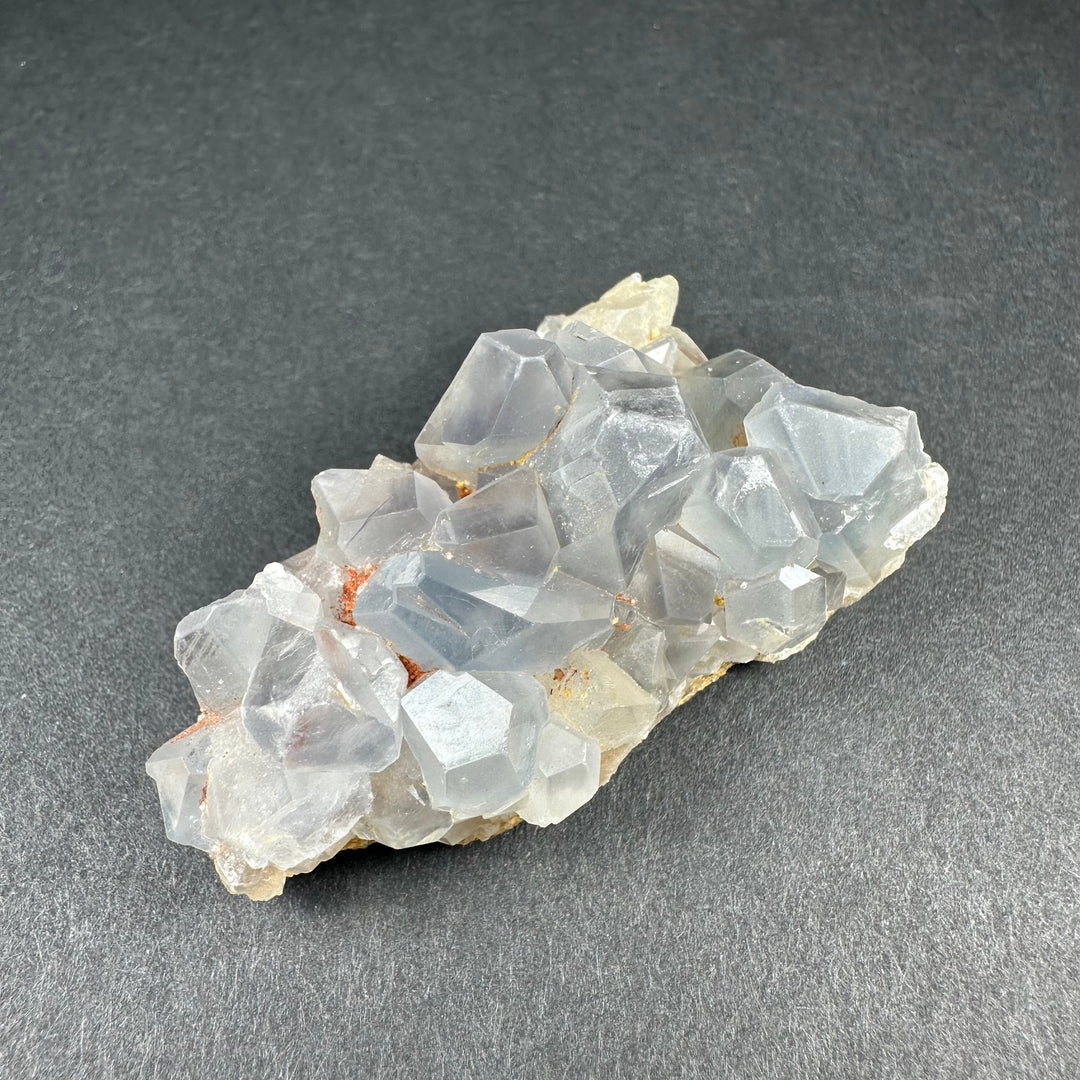 Celestite crystal cluster on tan matrix with pale blue translucent cube-like crystals