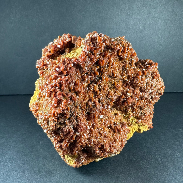 Vanadinite crystal specimen on matrix, dense copper-orange crystals over dark rock
