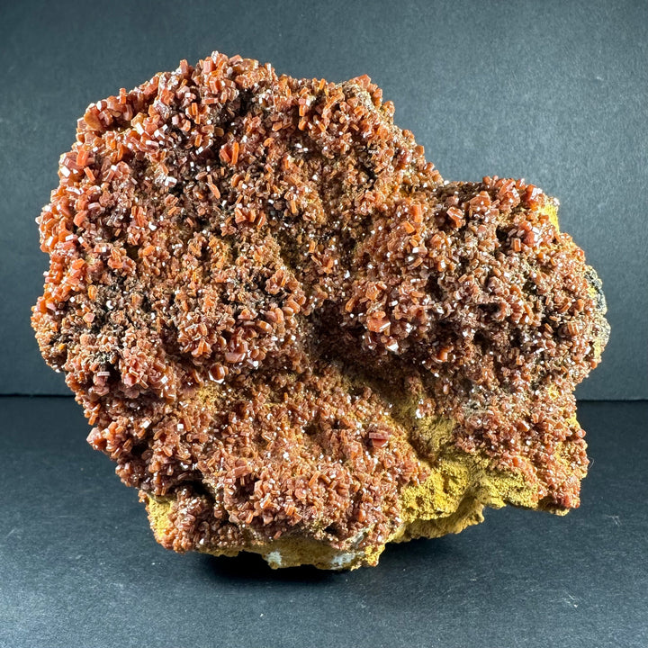 Vanadinite crystals on matrix, orange-red cluster with greenish yellow pockets