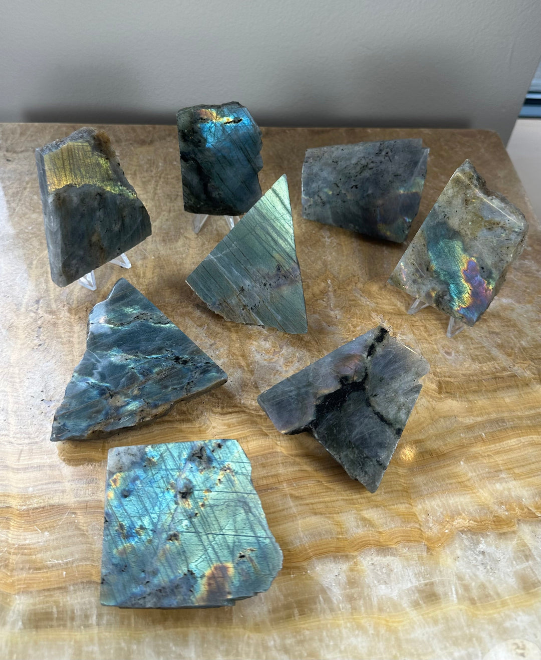 Assorted polished labradorite slabs with iridescent blue and teal sheen
