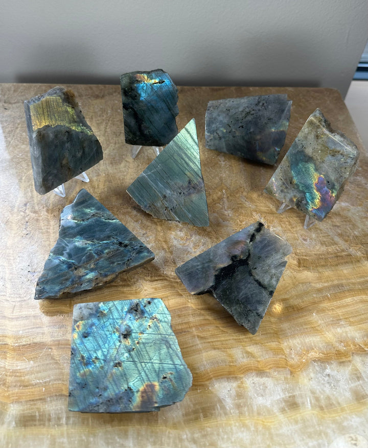 Assorted polished labradorite slabs with iridescent blue and teal sheen