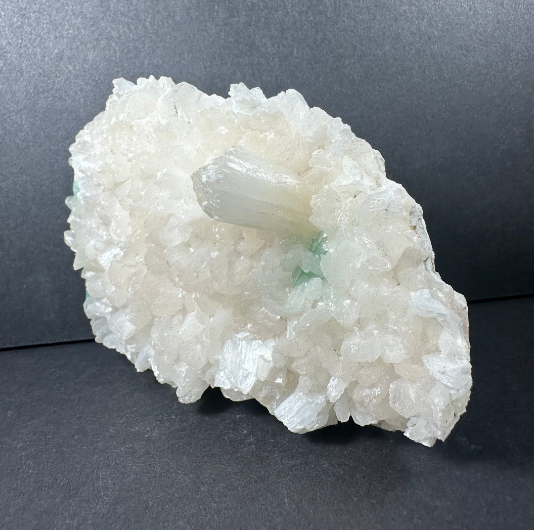 Mineral crystal cluster on matrix with white crystals and small mint-green accents