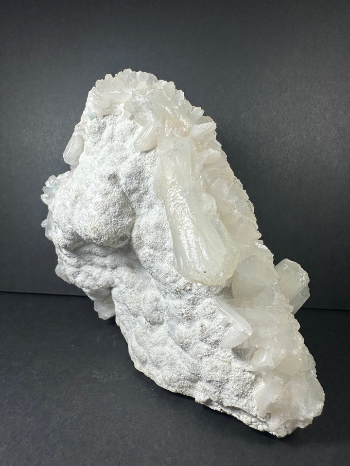 White mineral cluster with clear crystal points and chalky matrix texture