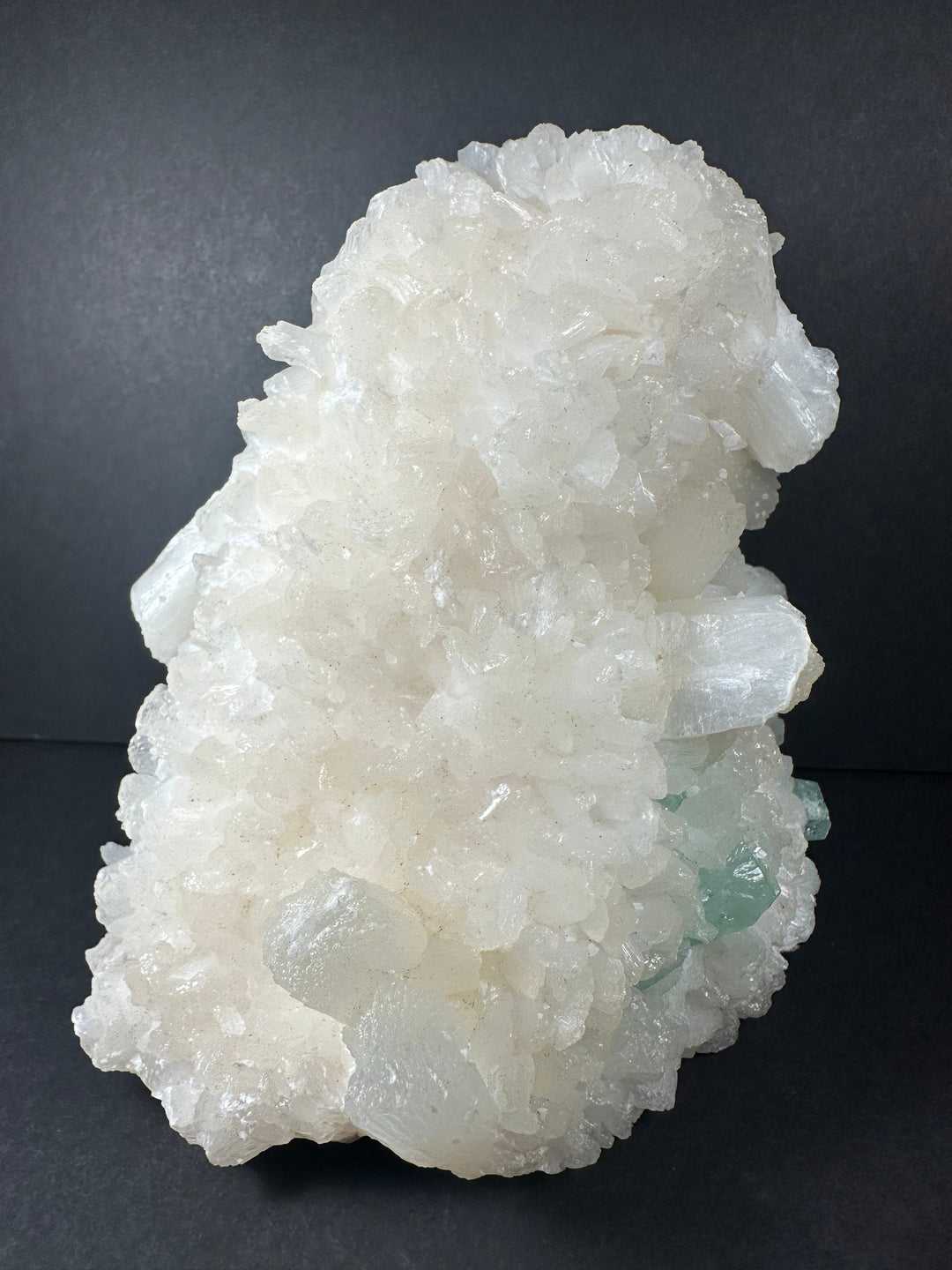 White crystal cluster with pale green nodes on druzy matrix